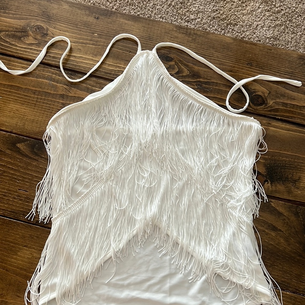 White tank, ties around the neck with fringe.
